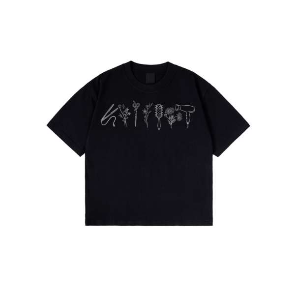 Hairstylist T-Shirt with floral salon tool print on black cotton fabric